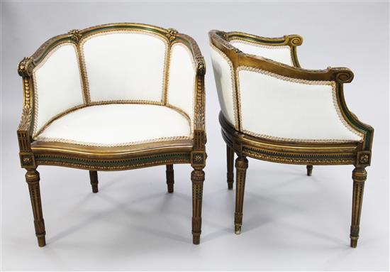 A pair of Louis XVI style green painted and parcel gilt tub shaped bergeres,